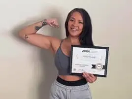 Female graduate showing ISSA Fitness Certification India certificate
